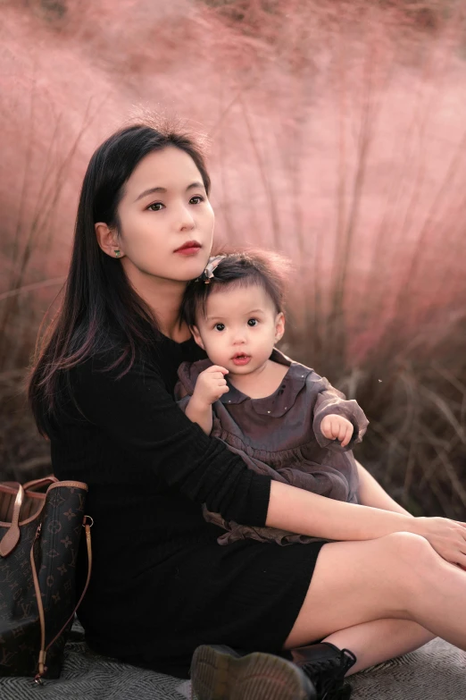 a woman sitting on a rock holding a baby, inspired by Ruth Jên, instagram, wearing a dark dress, ulzzang, profile image, 1 5 6 6