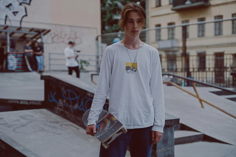 a young man holding a skateboard in a skate park, a polaroid photo, by Attila Meszlenyi, realism, off - white collection, alexey egorov, innocent face, anna nikonova aka newmilky