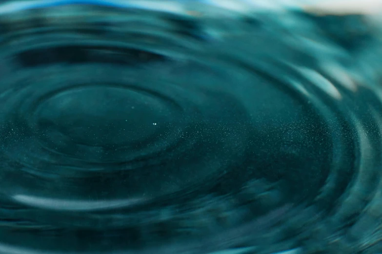 a close up of a glass of water, inspired by Lucio Fontana, trending on unsplash, hurufiyya, teal, whirlpool, made of liquid, high-quality render