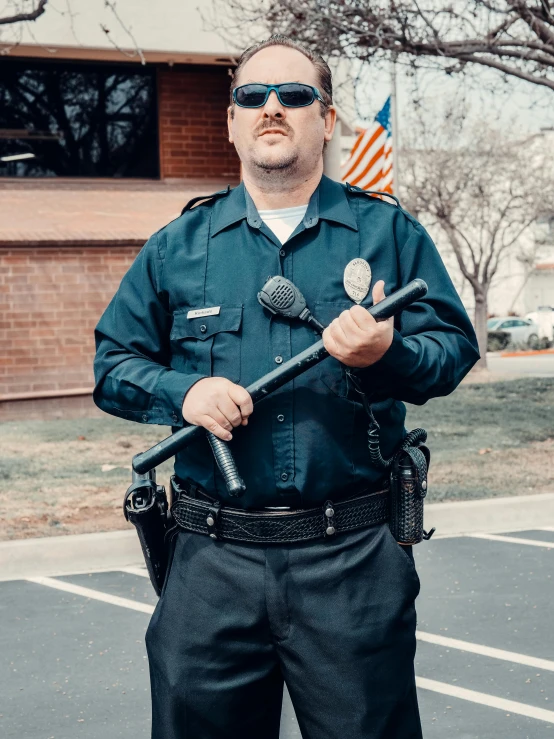 a police officer standing in a parking lot, an album cover, unsplash, holding a thick staff, high quality costume, 2019 trending photo, standing microphones