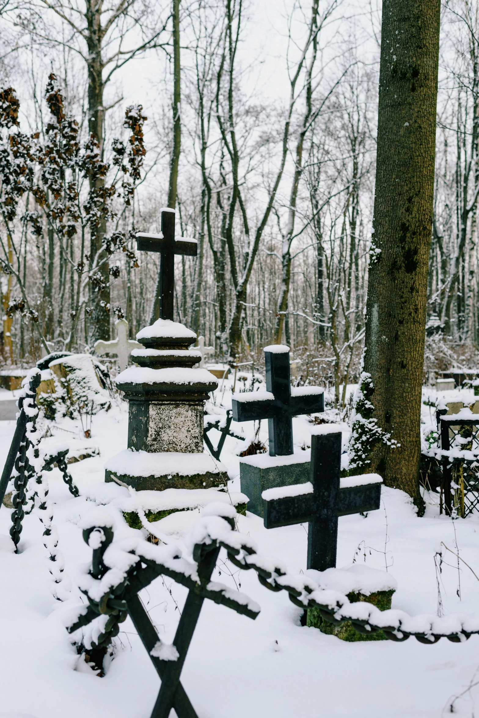 a cemetery in the woods covered in snow, by Adam Szentpétery, historical setting, eastern european, contain