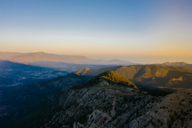 a view of the mountains from the top of a mountain, by Alexis Grimou, golden hour 4k, greece, fan favorite, birds - eye view