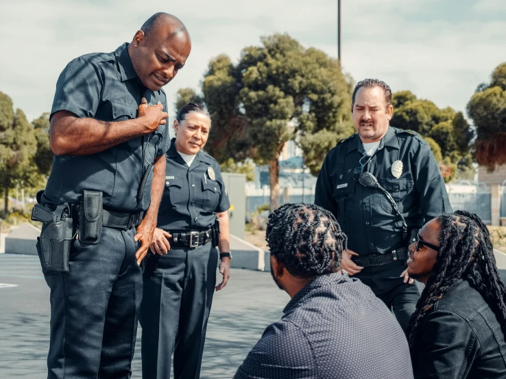 a group of police officers standing next to each other, pexels contest winner, happening, california, panel of black, on location, ( ( theatrical ) )