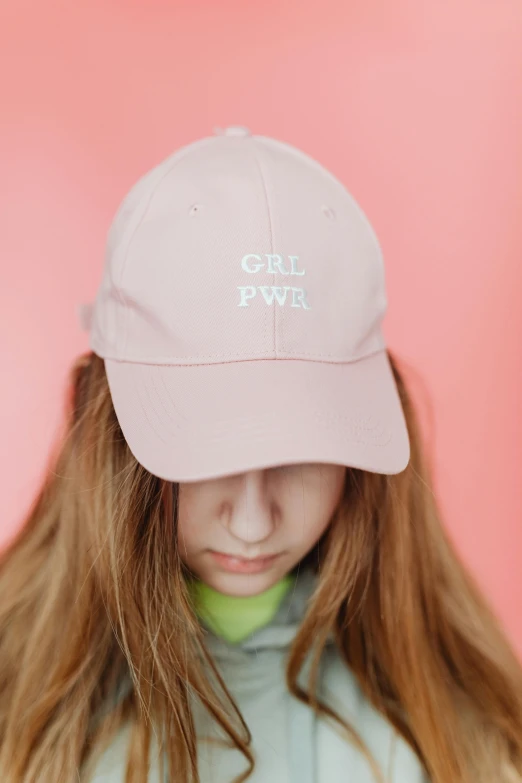 a girl with long hair wearing a pink hat, by Rachel Reckitt, trending on pexels, with names, highly detailed product photo, pale pastel colours, college girls