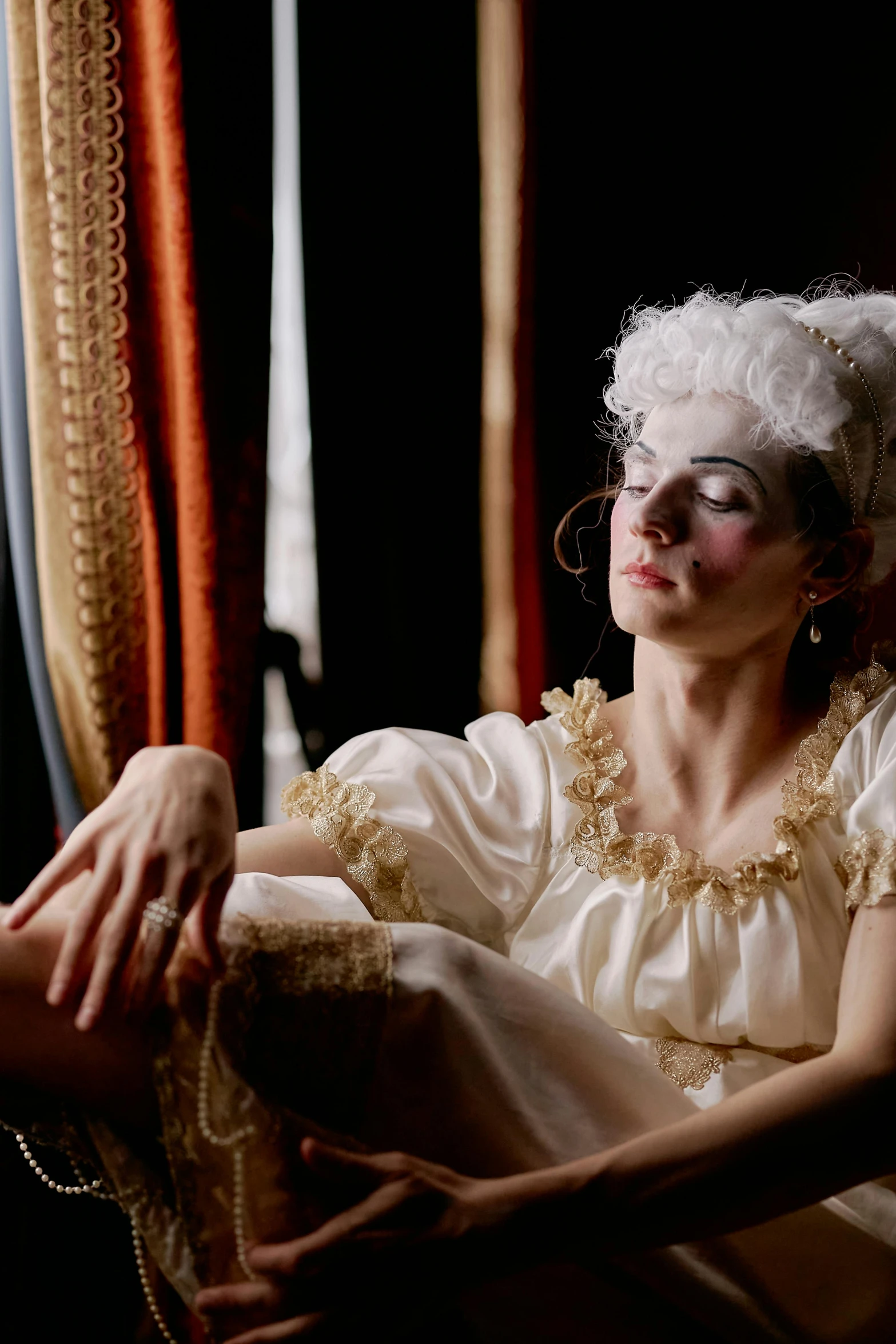a woman in a white dress sitting on a chair, a portrait, inspired by Karl Bryullov, pexels, rococo, movie still of a tired, silk stockings, slide show, ( ( theatrical ) )