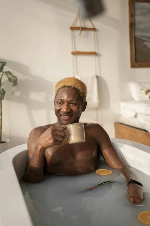 a man sitting in a bathtub holding a cup of coffee, a stock photo, featured on reddit, renaissance, grey skinned, ignant, golden hues, barrel chested