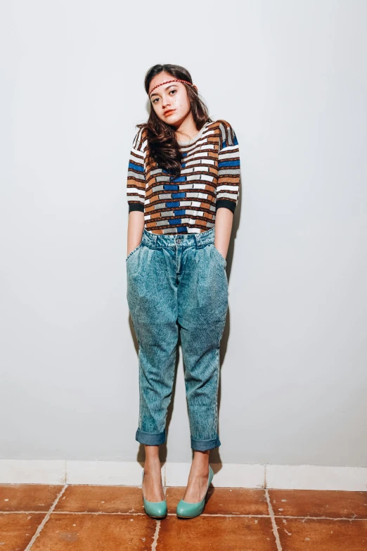 a woman standing on top of a tiled floor, by Oka Yasutomo, trending on pexels, renaissance, baggy jeans, studio portrait, kat dennings, wearing stripe shirt