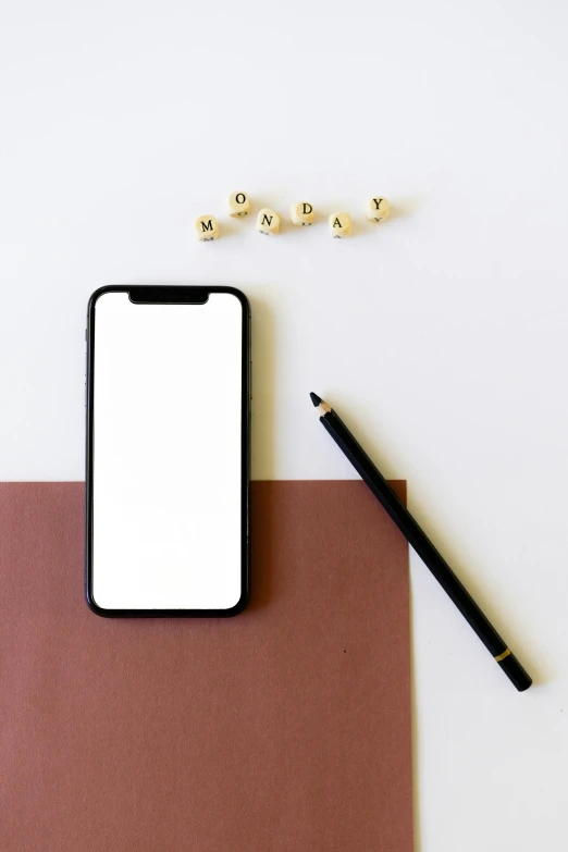 a phone sitting on top of a piece of paper next to a pencil, by Carey Morris, trending on pexels, minimalism, square, 15081959 21121991 01012000 4k, white minimalistic background, brown and white color scheme