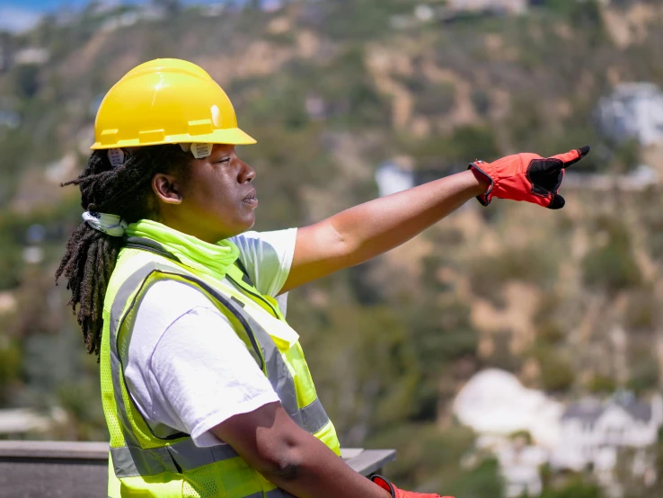 a man in a hard hat pointing at something, unsplash, lupita nyong'o, mulholland drive, wearing gloves, avatar image