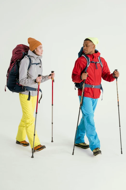 a couple of men standing next to each other on skis, inspired by Salomon van Abbé, hiking clothes, mix of ethnicities and genders, red and teal and yellow, thumbnail