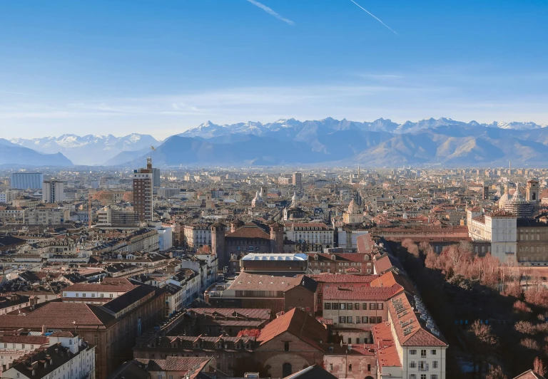 a view of a city with mountains in the background, inspired by Bernardo Bellotto, pexels contest winner, renaissance, 4k photo gigapixel, sunny day time, judy chicago, high angle view