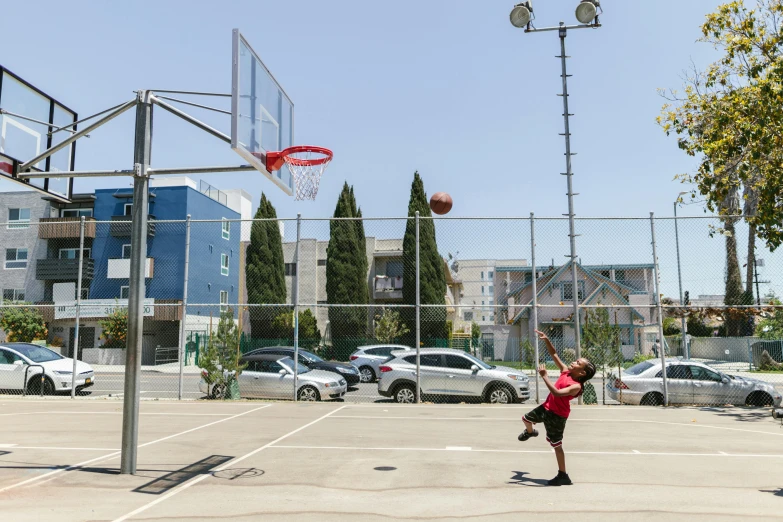 a man standing on top of a basketball court holding a basketball, by Michael Goldberg, square, view from the streets, 15081959 21121991 01012000 4k, mid action swing