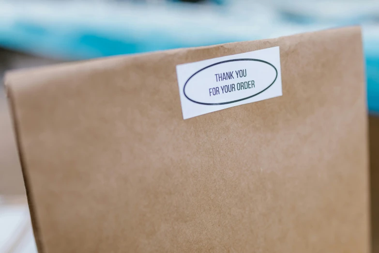 a close up of a box with a sticker on it, by Daniel Taylor, unsplash, private press, thank you, brown resin, customers, decoration