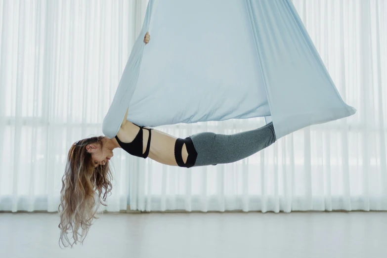 a woman hanging upside down on a hammock, by Emma Andijewska, arabesque, silks, sydney hanson, in flight, profile image