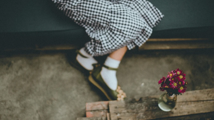 a person sitting on a bench with a flower in a vase, trending on unsplash, wearing skirt and high socks, green and white, overalls, rubber waffle outsole