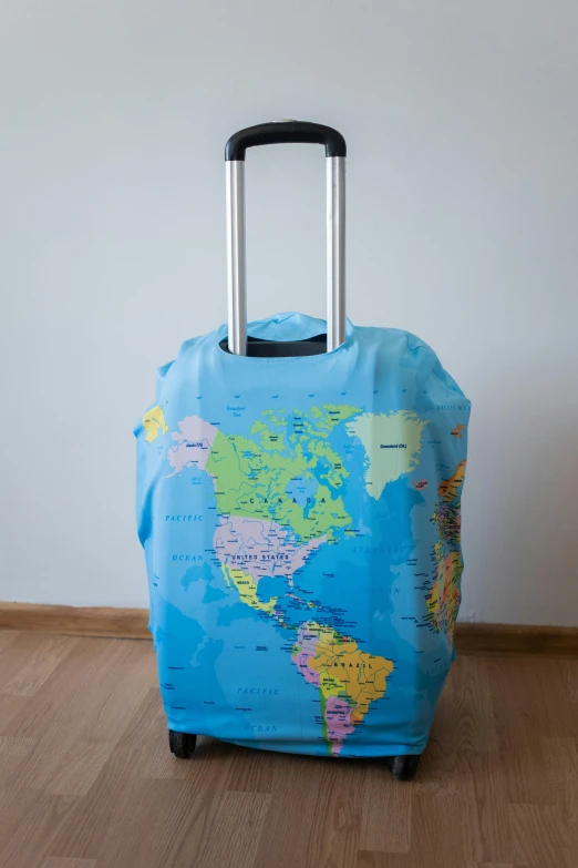 a suitcase covered with a map of the world, happening, long blue-cape, silicone cover, view(full body + zoomed out), product image