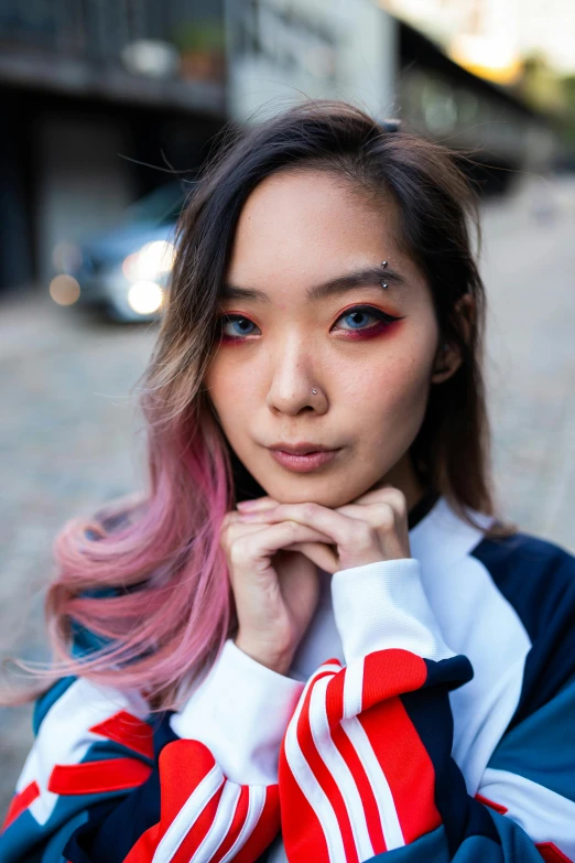 a woman with pink hair is posing for a picture, trending on pexels, photorealism, half asian, red and blue eyes, woman in streetwear, red contact lenses