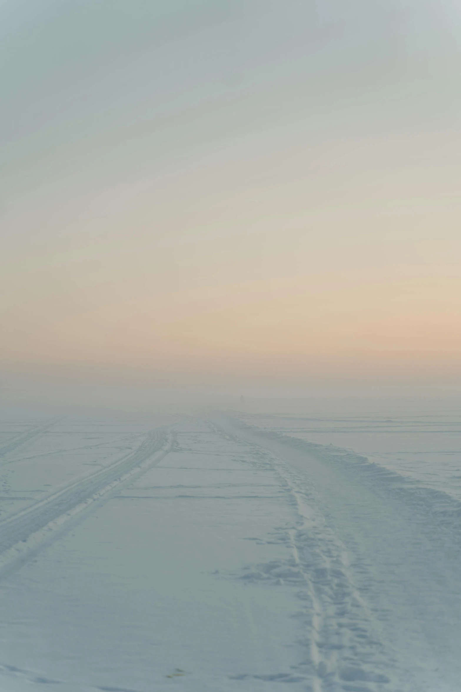 a man riding skis down a snow covered slope, an album cover, inspired by Einar Hakonarson, unsplash, romanticism, empty road in the middle, the sky is a faint misty red hue, inuk, runway photo