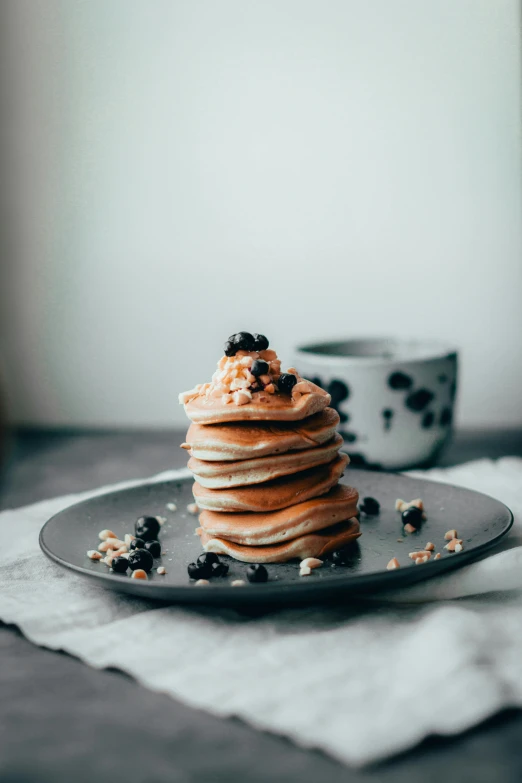 a stack of pancakes sitting on top of a plate, a still life, unsplash, profile image, thumbnail, stroopwaffel, indigo