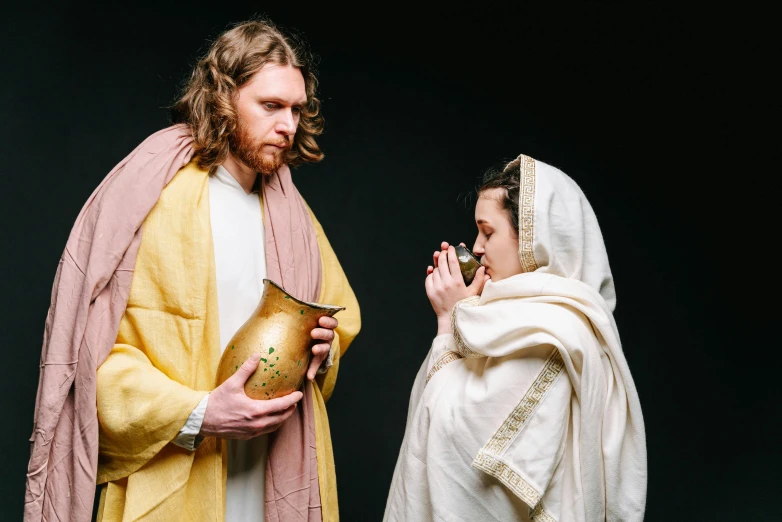 a man and a woman dressed as jesus and mary, unsplash, vessels, drinking, ( ( theatrical ) ), master pieces