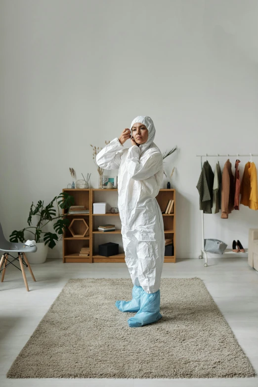 a person standing on a rug talking on a cell phone, hazmat suits, full body sarcastic pose, messy room, gen z