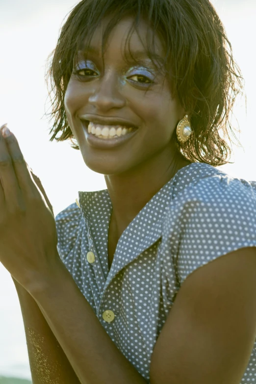 a close up of a person holding a cell phone, an album cover, inspired by Shirley Teed, pexels, happening, smiling in heaven, blue checkerboard dress, praying posture, 1 9 9 7