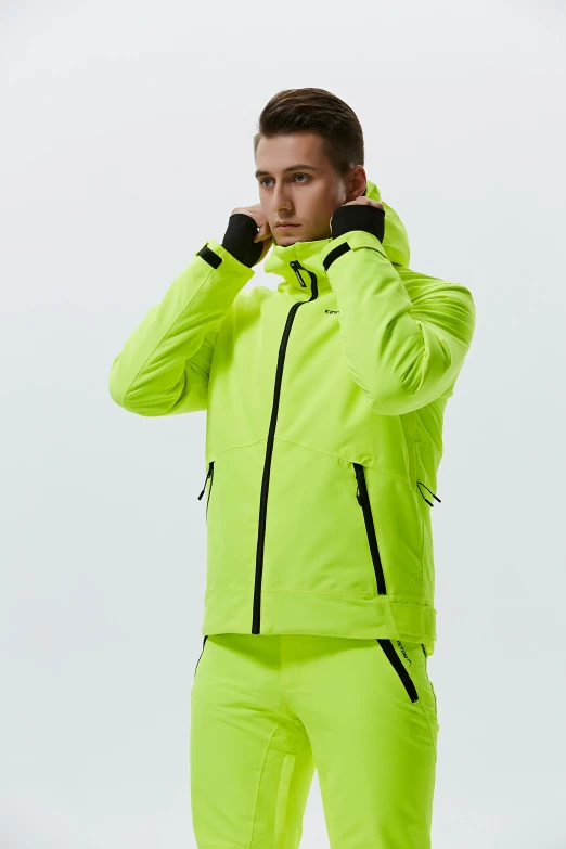 a man in a bright green jacket and pants, model is wearing techtical vest, detailed product image, colors: yellow, off white