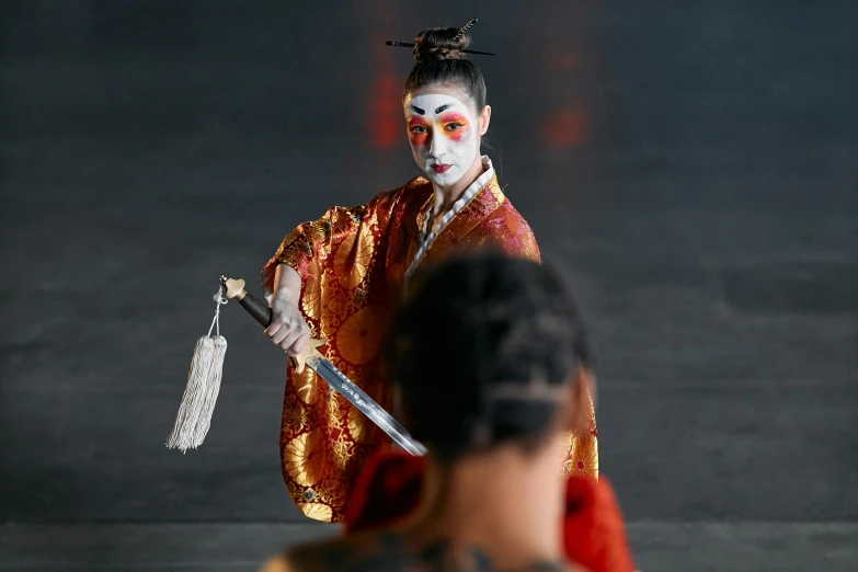 a woman dressed as a geisha holding a sword, pexels contest winner, two still figures facing camera, dance scene, rectangle, ceremonial ritual