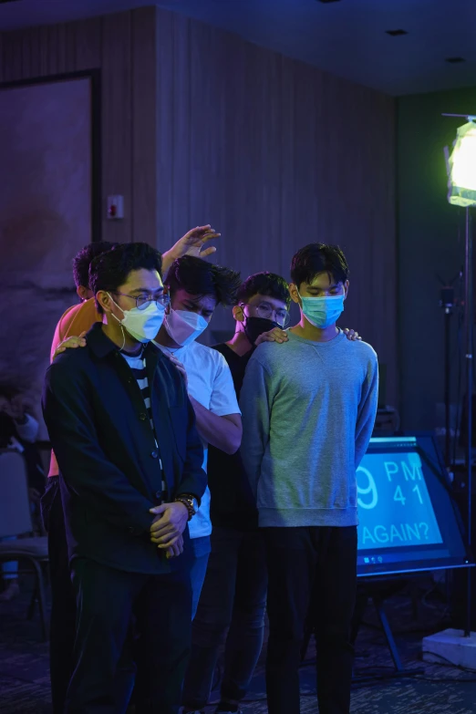 a group of people standing next to each other in a room, an album cover, by Robbie Trevino, pexels, serial art, surgical mask covering mouth, generic kpop boy band, concert, performing a music video