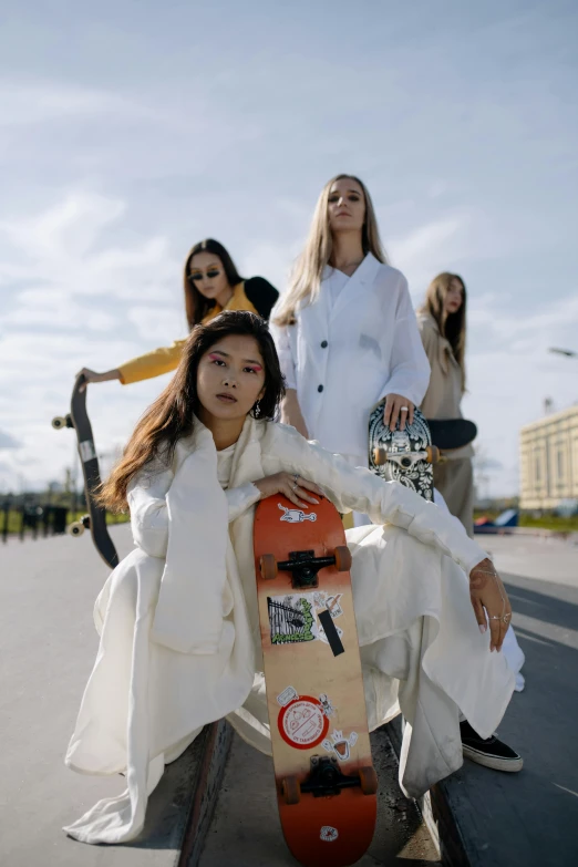 a group of women sitting on top of a skateboard, by Emma Andijewska, wearing white suit, trending on r/streetwear, alexey gurylev, promotional image