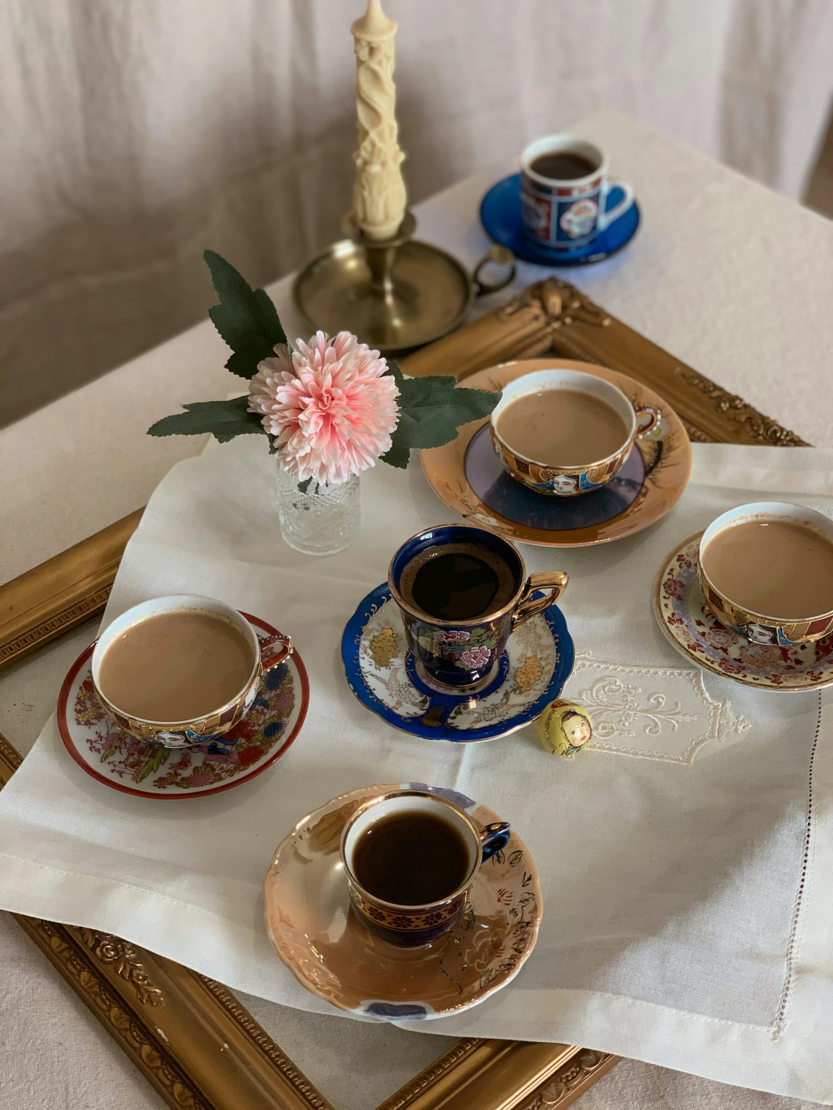 a table topped with coffee cups and saucers, by Alice Rahon, trending on unsplash, cloisonnism, low quality photo, thumbnail, orthodox, taken on iphone 14 pro