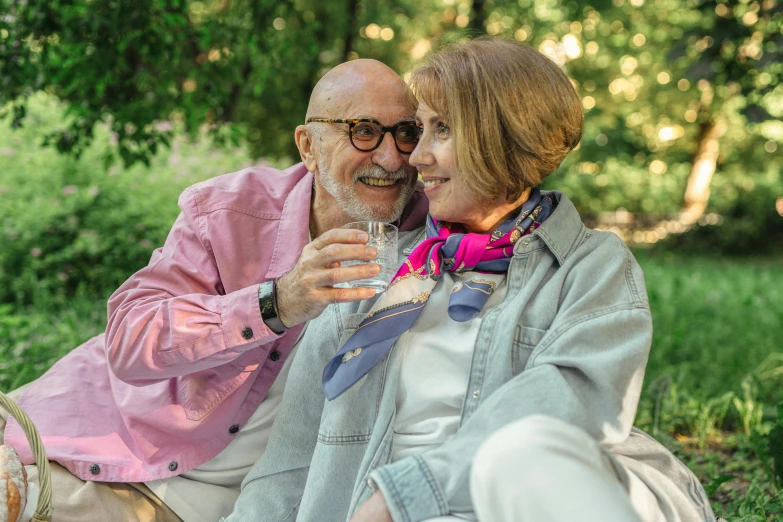 a man and a woman sitting next to each other, pexels contest winner, photorealism, garden behind the glasses, drinking, older male, in style of joel meyerowitz