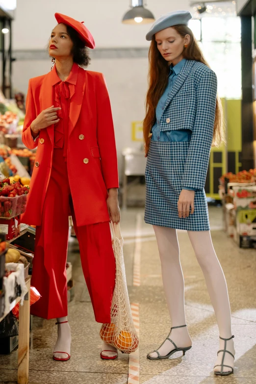 a couple of women standing next to each other, by Julia Pishtar, red suit, people shopping, wearing a light blue suit, trending on cgisociety