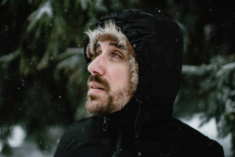 a man in a black jacket standing in the snow, a portrait, inspired by Hallsteinn Sigurðsson, pexels contest winner, asmongold, headshot profile picture, colin greenwood (bass), hooded