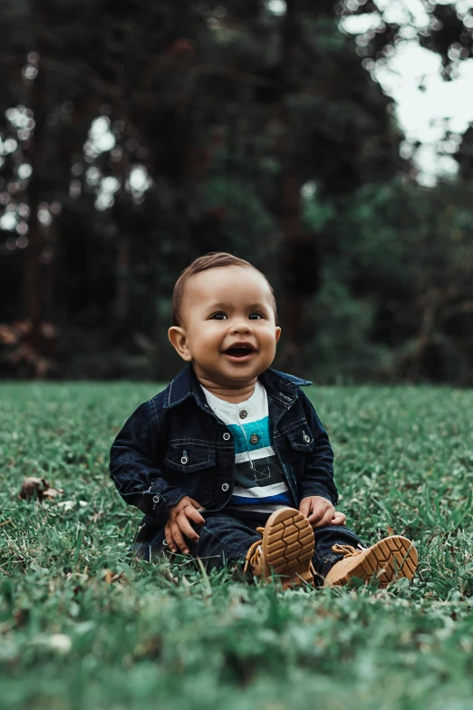 a little boy that is sitting in the grass, instagram picture, lachlan bailey, super high resolution, smiling