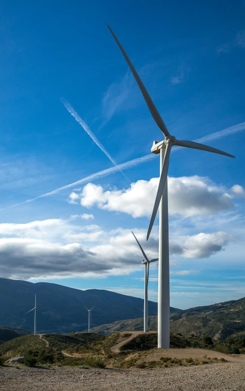 a group of wind turbines sitting on top of a hill, profile image