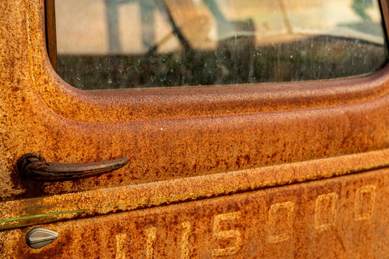 a close up of an old rusted truck door, an album cover, by Jim Nelson, unsplash, precisionism, dipstick tail, classic cars, museum quality photo, taken in the early 2020s