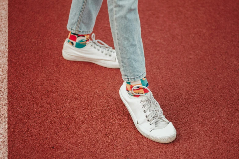 a close up of a person's shoes on a track, inspired by Okuda Gensō, trending on pexels, renaissance, wearing jeans, teal silver red, modeled, patterned