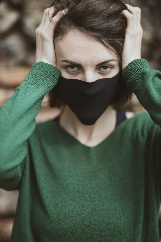 a woman with a face mask covering her face, by Adam Marczyński, trending on pexels, renaissance, wearing a green sweater, wearing a black shirt, head to waist, fabric