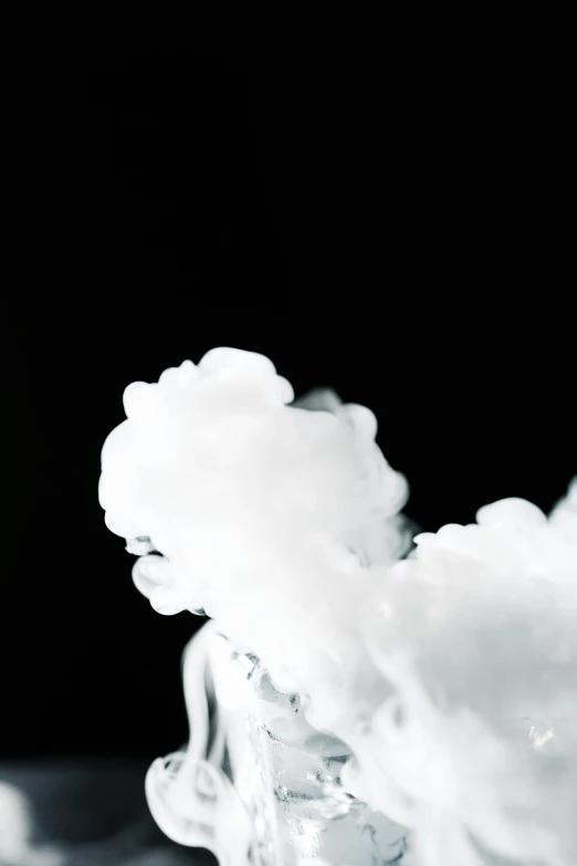 a glass filled with liquid sitting on top of a table, by Robbie Trevino, unsplash, process art, white thick smoke, face made out of clouds, abstract claymation, white and black