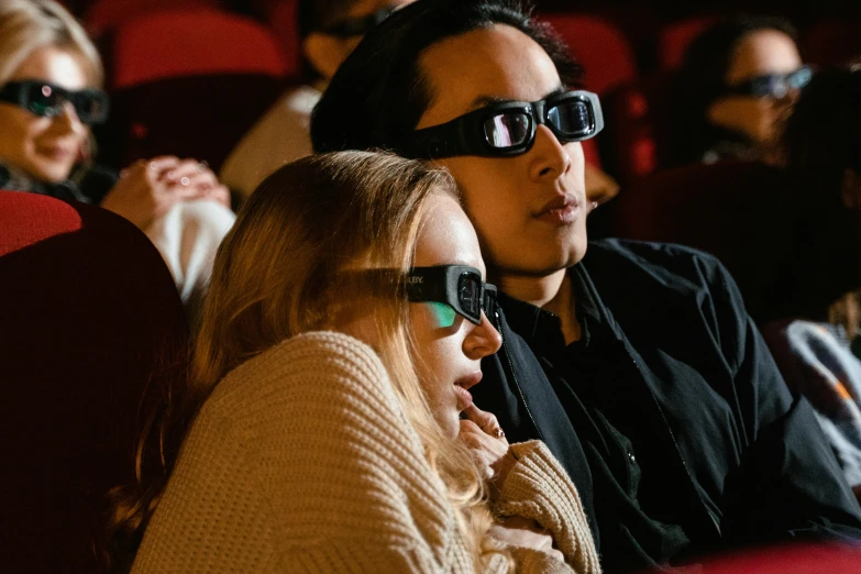 a group of people sitting in a theater wearing 3d glasses, pexels, hyperrealism, couple, jordan grimmer and natasha tan, close up to the screen, instagram post