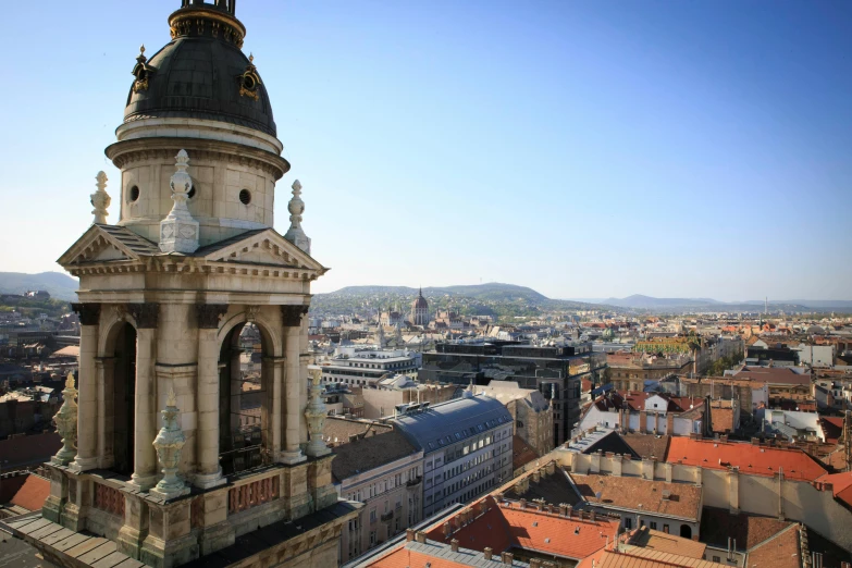 a tall tower with a clock on top of it, inspired by Bertalan Székely, pexels contest winner, baroque, skyline view from a rooftop, square, budapest, daniel libeskind