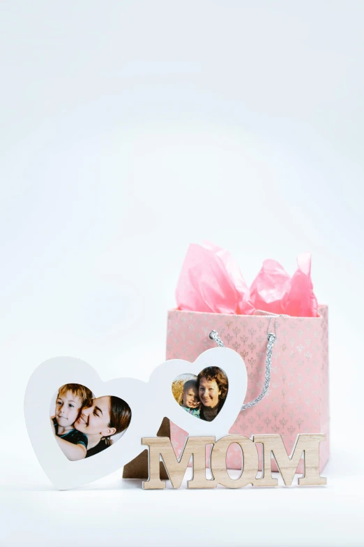 a pink gift box sitting next to a couple of photos, a picture, pop figure of mom with long, portrait n - 9, f / 3, - 9