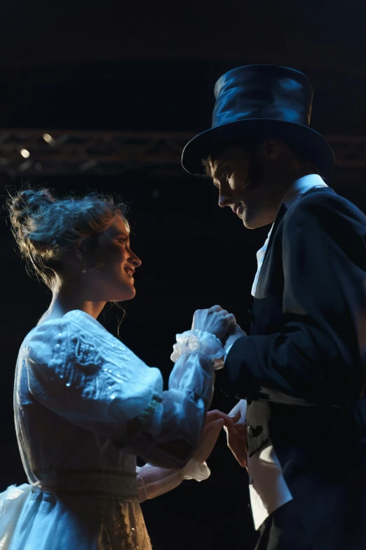 a couple of people standing next to each other on a stage, by Alice Mason, romanticism, wearing a top hat, profile image, ( ( theatrical ) ), underground scene