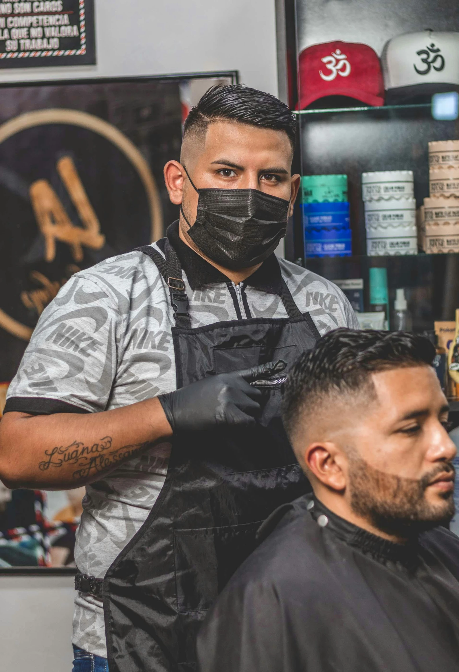 a man getting a haircut at a barber shop, wearing a mask, eloy morales, rugged textured face, background bar