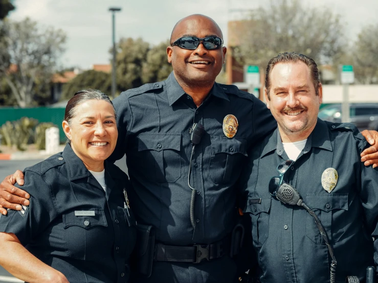 a group of police officers standing next to each other, a portrait, unsplash, smiling for the camera, avatar image, los angelos, neighborhood