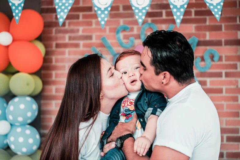 a man kissing a woman while holding a baby, pexels contest winner, birthday party, background image, 1614572159, grafit studio