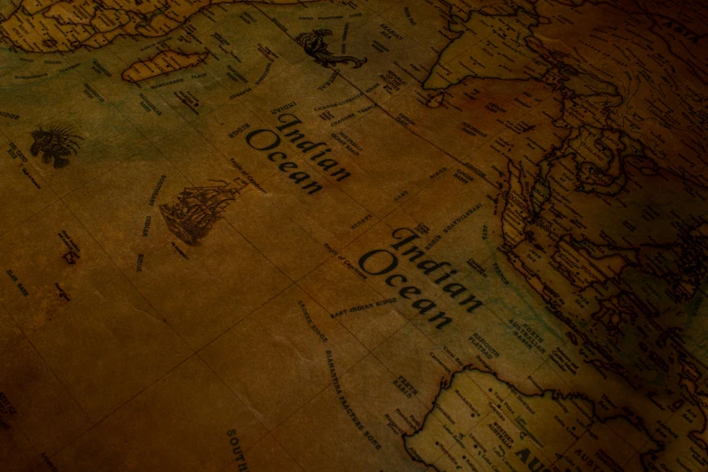 a close up of a map on a table, an album cover, trending on unsplash, digital art, colonial expedition, background image, ocean dept, orientalism