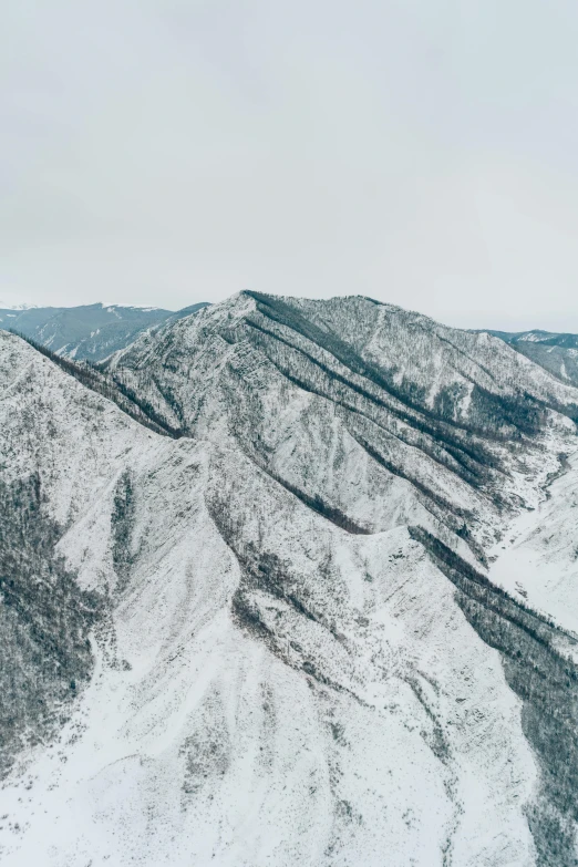 a man flying through the air while riding a snowboard, by Kim Tschang Yeul, trending on unsplash, sōsaku hanga, “ aerial view of a mountain, japonisme 3 d 8 k ultra detailed, panorama view, canyons