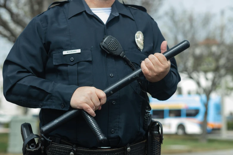 a man in a police uniform holding two batons, unsplash, patterned, blank, schools, high quality product image”